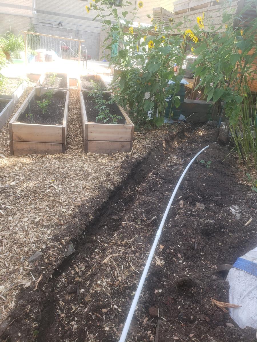 PVC pipe fittings laid out to build an aeration manifold for the composting bin